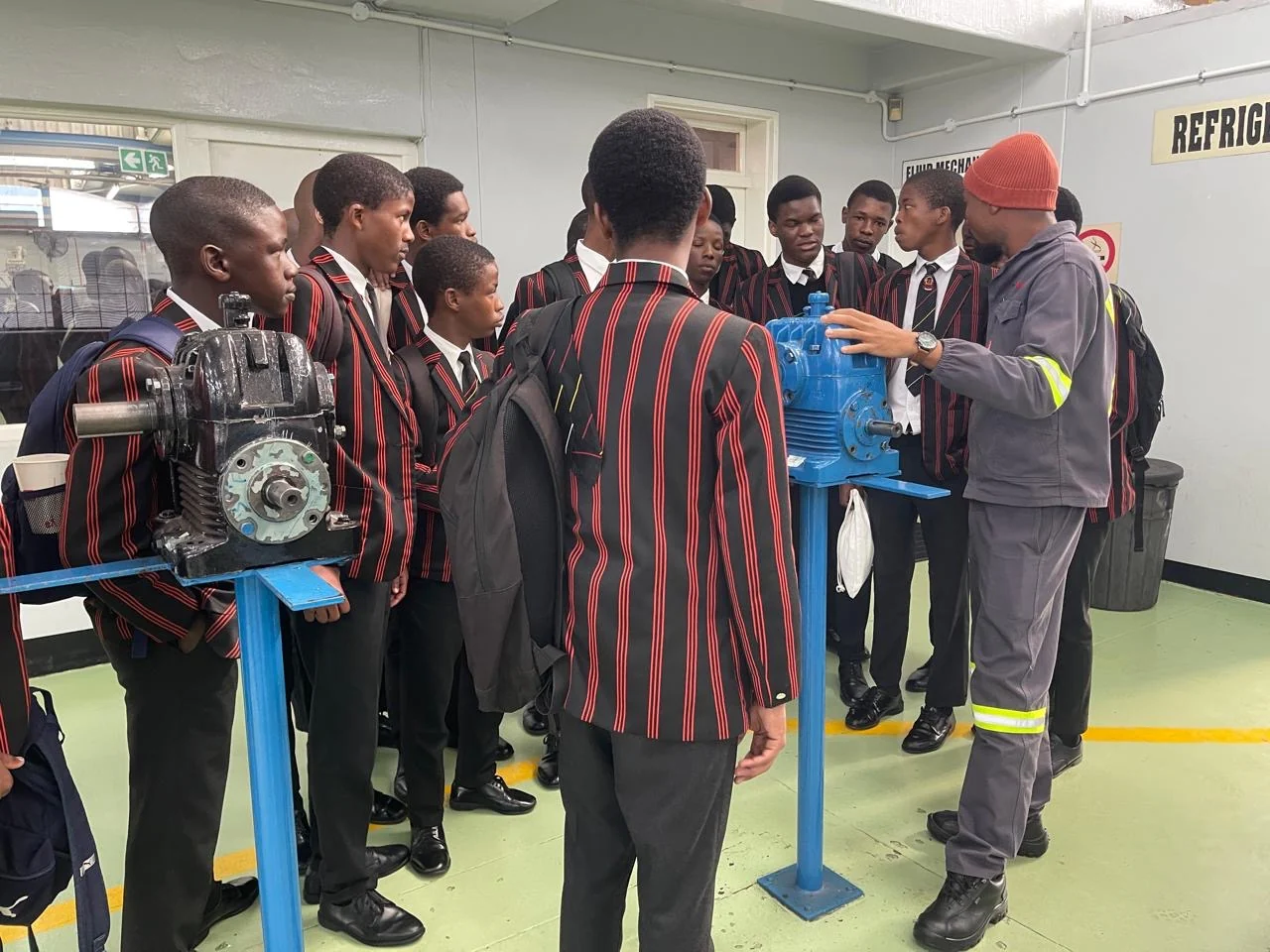 Learners exploring mechanical systems with an instructor