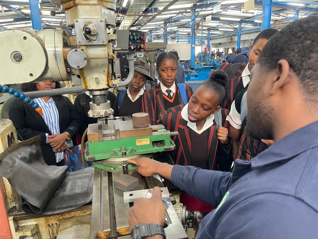 Learners observing workshop equipment