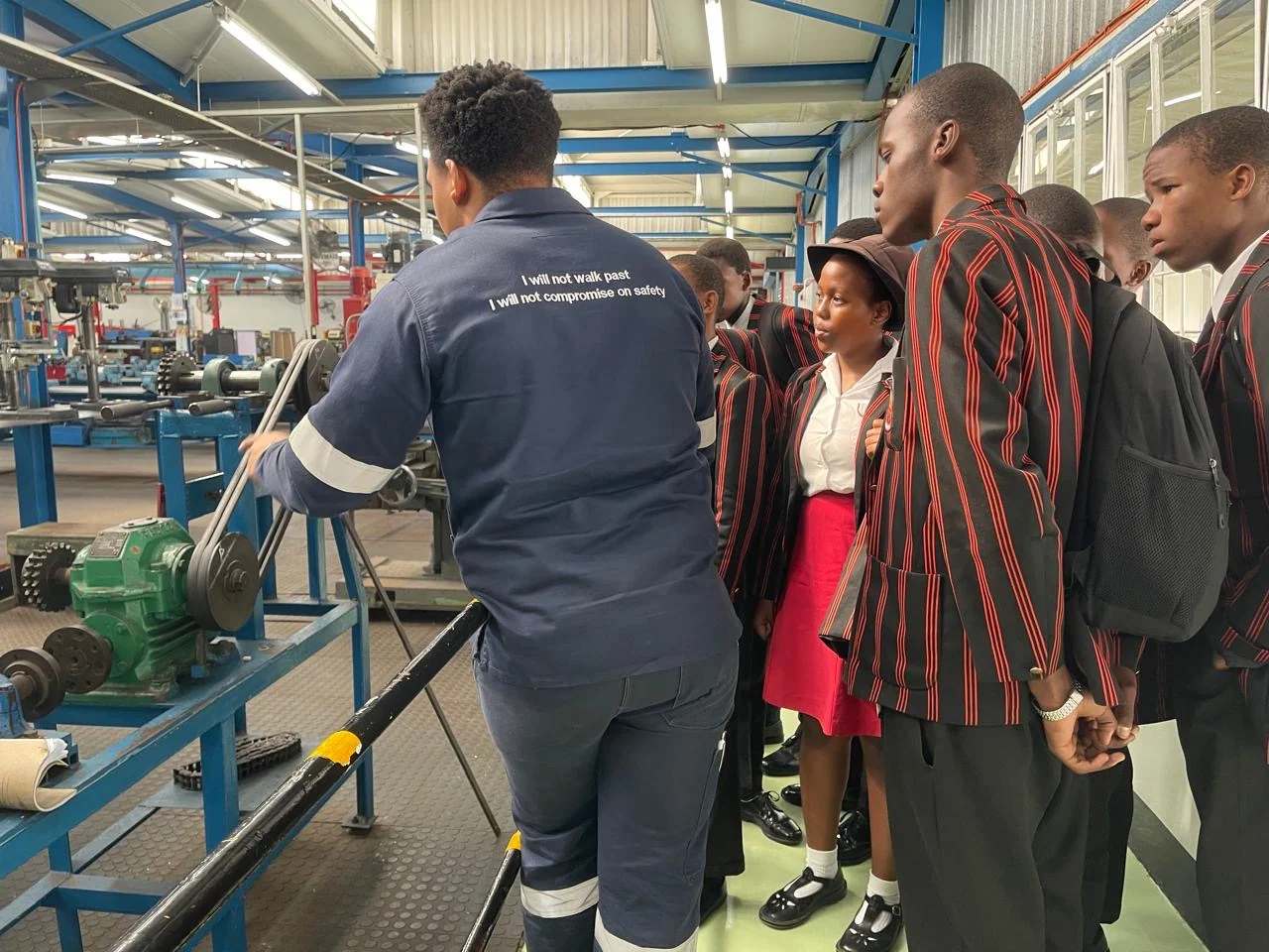 Learners observing a mechanical workshop demonstration